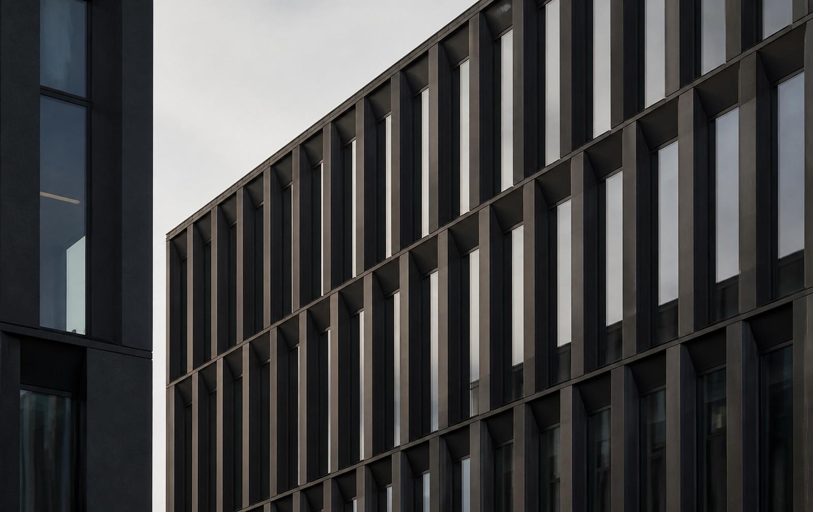 Abstract facade of a modern European office building with rhythmic vertical fins
